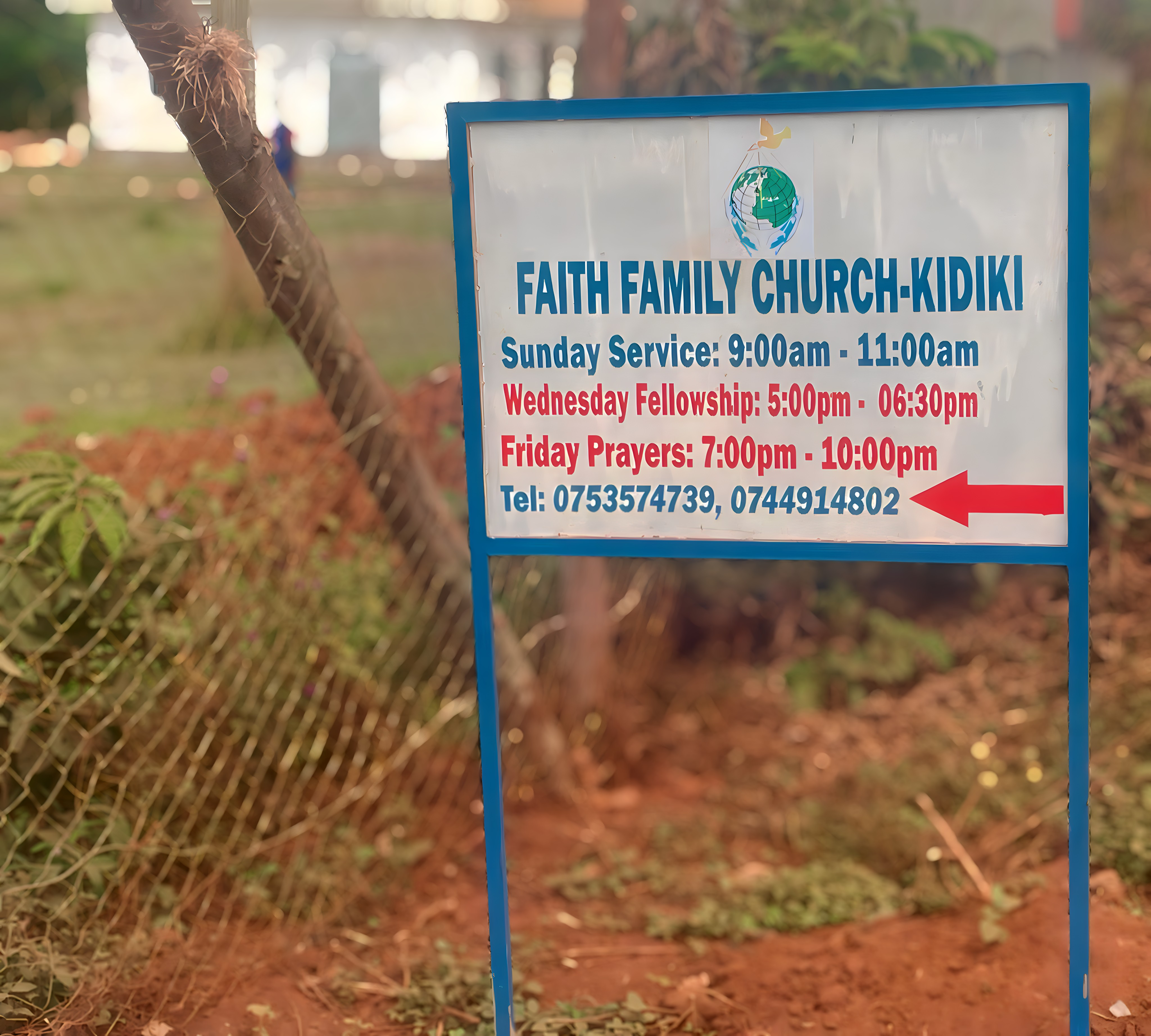 Church signpost showing service times and contact information